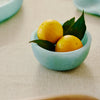 Small aqua resin bowl styled on a coastal table setting with natural textures