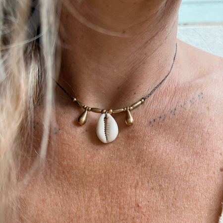 Cowrie Brass Teardrop Necklace - detail view | Travel & Tide