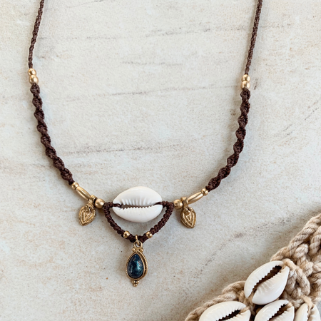 Cowrie and lapis lazuli necklace with natural shell and deep blue gemstone, handcrafted coastal bohemian jewelry