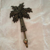 Antique brass coconut palm hook large size showing full palm tree detail with coconut clusters and textured trunk
