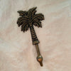 Antique brass coconut palm hook medium size with detailed palm fronds and rounded brass hook tip
