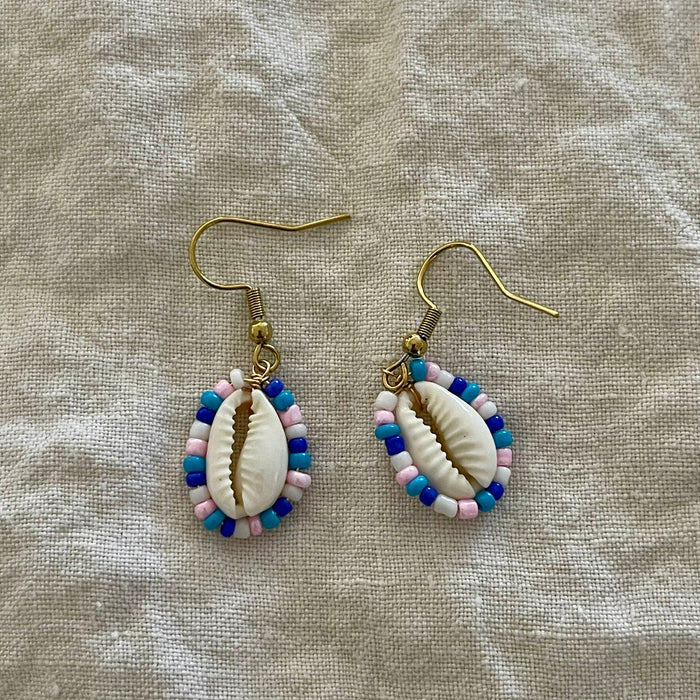 Beaded cowrie earrings with blue, white and pink seed beads on gold hooks
