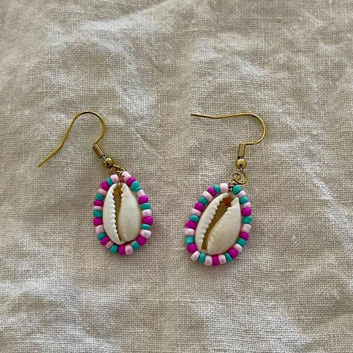 Beaded cowrie shell earrings with pink and blue seed beads on gold hooks
