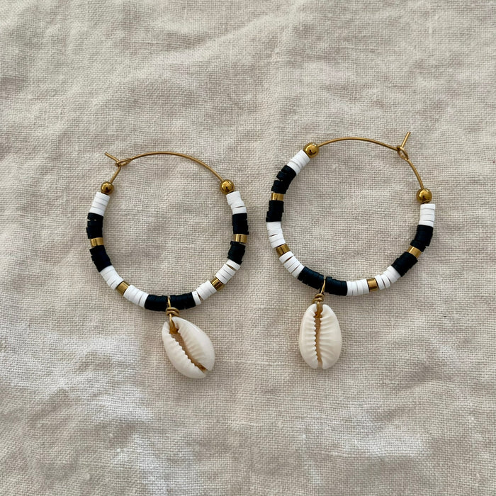 Black polymer clay bead hoop earrings with natural cowrie shell drop and gold-tone accents
