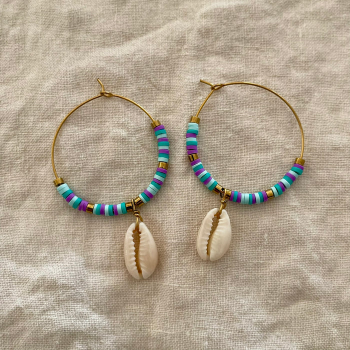 Blue and purple polymer clay bead hoop earrings with natural cowrie shell drop and gold-tone accents
