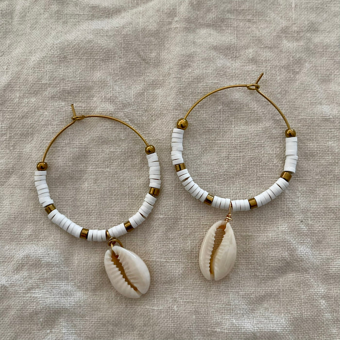 White polymer clay bead hoop earrings with gold-tone accents and natural cowrie shell drop
