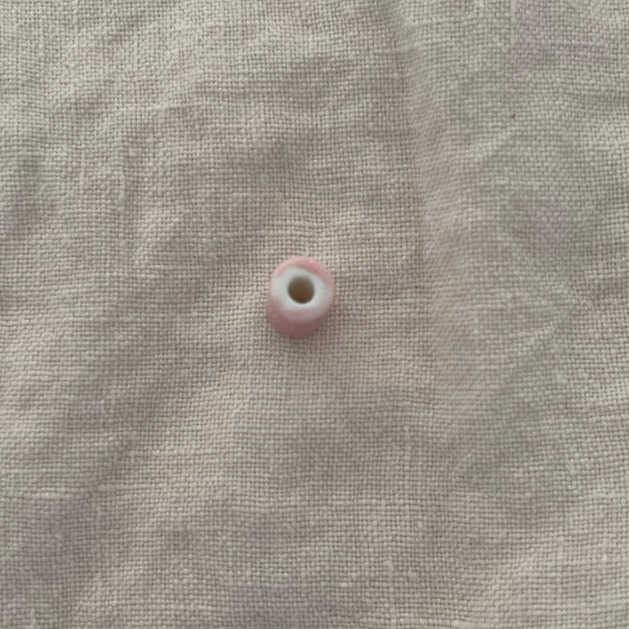 Blush pink ceramic barrel bead showing wide stringing hole - Travel and Tide Coastal Notions
