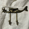 Antique brass mermaid double wall hook with starfish detail, full product view on white linen background

