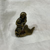 Antique brass mermaid drawer knob with shell detail, front view on white linen background
