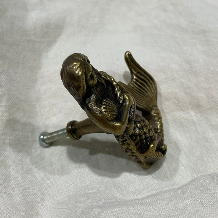 Side view of brass mermaid drawer knob showing screw fitting and scaled tail detail
