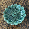 Green glazed ceramic lotus incense holder, overhead view showing deep teal-green glaze and layered petal detail
