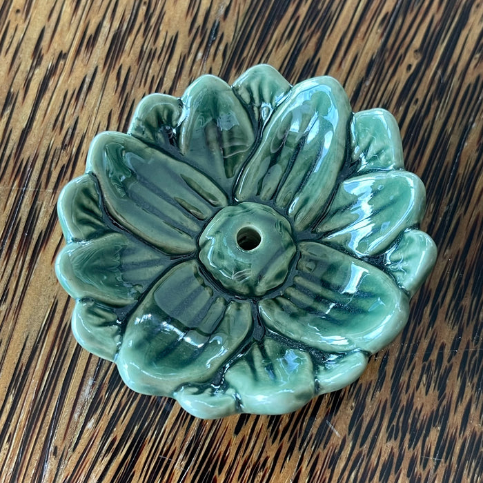 Green glazed ceramic lotus incense holder, overhead view showing deep teal-green glaze and layered petal detail
