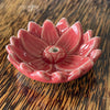 Blue glazed ceramic lotus flower incense holder, angled view showing smooth rounded petals and central incense hole
