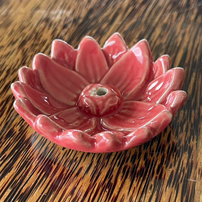 Blue glazed ceramic lotus flower incense holder, angled view showing smooth rounded petals and central incense hole
