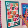 Reusable fabric Christmas Advent Calendar filled with small gifts and treats in a festive styled home
