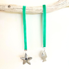 Coastal velvet Fish and Star hangers styled on a Christmas tree with coastal festive decorations
