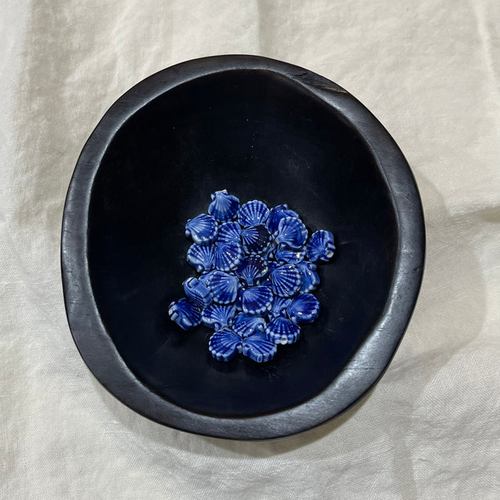 Cobalt blue ceramic scallop shell beads in a dark bowl - Travel and Tide Coastal Notions

