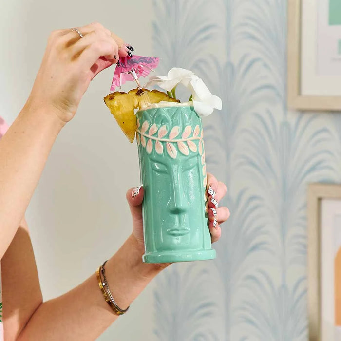 Tiki cocktail cup in ceramic with glossy glaze and embossed tropical design

