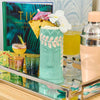 Tiki cocktail cup filled with cocktail - tropical entertaining drinkware
