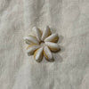 Small white cowrie shell flower charm on linen - Travel and Tide Coastal Notions
