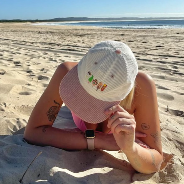 Person wearing the Down Under Delights embroidered corduroy hat outdoors
B