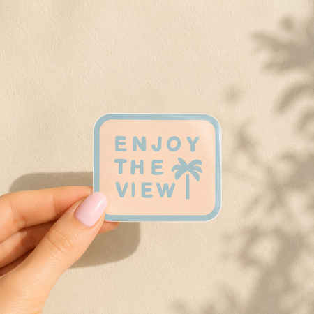 Glossy vinyl sticker with soft pastel coastal artwork and 'Enjoy the View' lettering