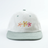 Front view of Flower Bloom Hat with three embroidered flower designs

