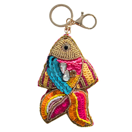 Fish-shaped keychain with cream beadwork, turquoise, pink, yellow and orange sequins, faceted gem-style accents and a gold-tone keyring and clasp
