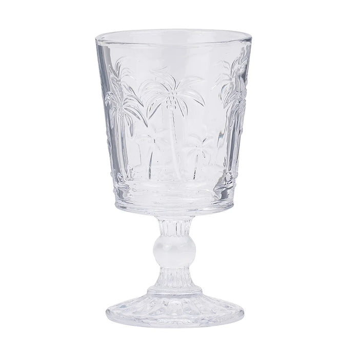 Set of 4 clear etched palm tree goblet glasses on a styled table
