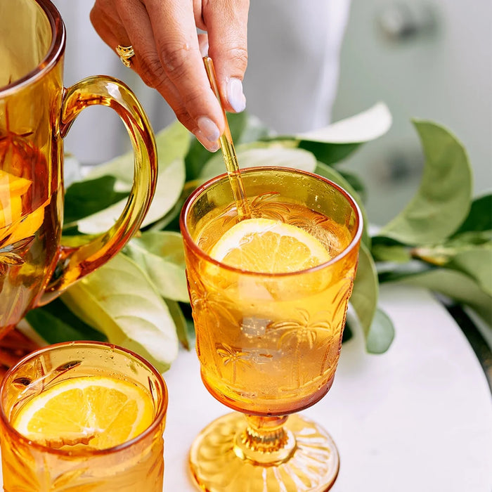 Palm goblet glasses in Clear, Amber and Blue styled together on an outdoor summer table setting
