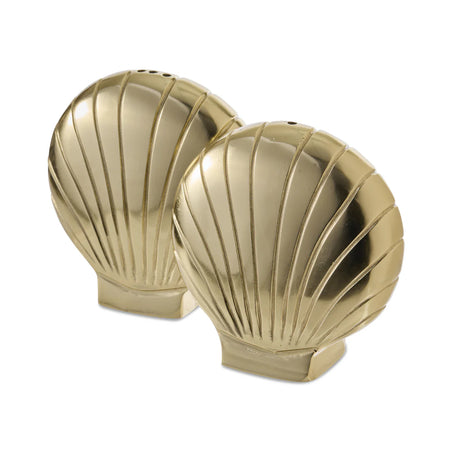Gold shell-shaped salt and pepper shaker set styled on a coastal dining table