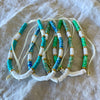 Gold trim bead anklets in dark blue, teal, turquoise and green with white shell beads and adjustable cord
