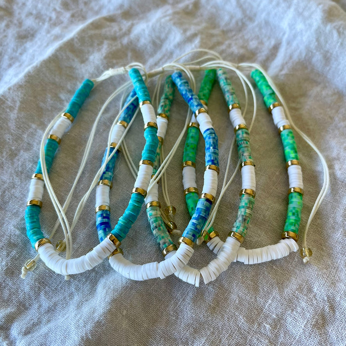 Gold trim bead anklets in dark blue, teal, turquoise and green with white shell beads and adjustable cord
