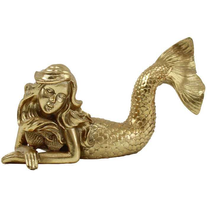 Gold resin laying mermaid sculpture with intricate scale tail detail and flowing hair on white background
