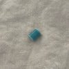 Light teal ceramic barrel bead on white linen - Travel and Tide Coastal Notions
