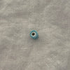 Light teal ceramic barrel bead showing wide stringing hole - Travel and Tide Coastal Notions
