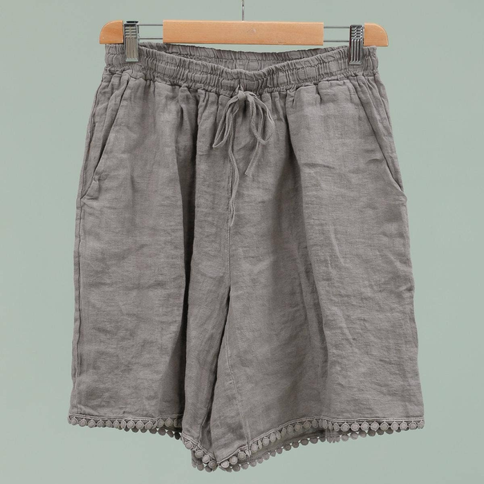 100% linen Bermuda shorts in taupe with pom-pom trim hem and elasticated drawstring waist on hanger
