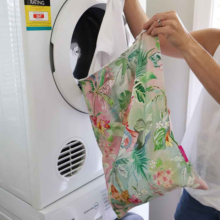 Linen Tiki laundry bag styled in bedroom - reusable linen cotton laundry storage
