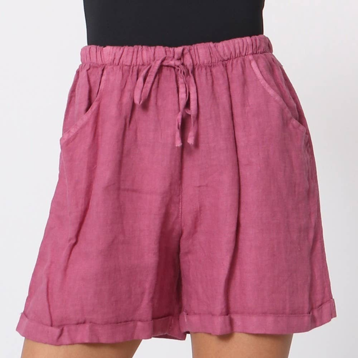 100% linen shorts in fuchsia with elasticated drawstring waist side pockets and cuffed hem worn by model
