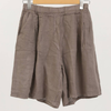 100% linen wide-leg Bermuda shorts in taupe with front pleats and patch pockets on hanger
