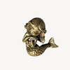 Close-up of a small brass mermaid with ocean-inspired coastal detail
