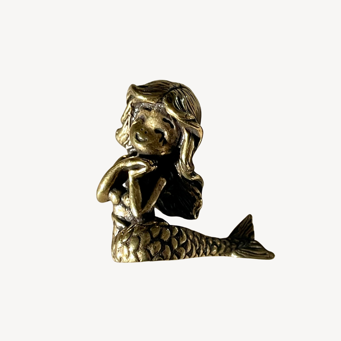 Little brass mermaid shown from the front, approximately 4cm tall
