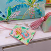 Tiki Island luggage tag attached to suitcase handle with loop strap
