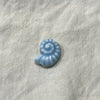 Ocean blue ceramic nautilus spiral bead on white linen - Travel and Tide Coastal Notions
