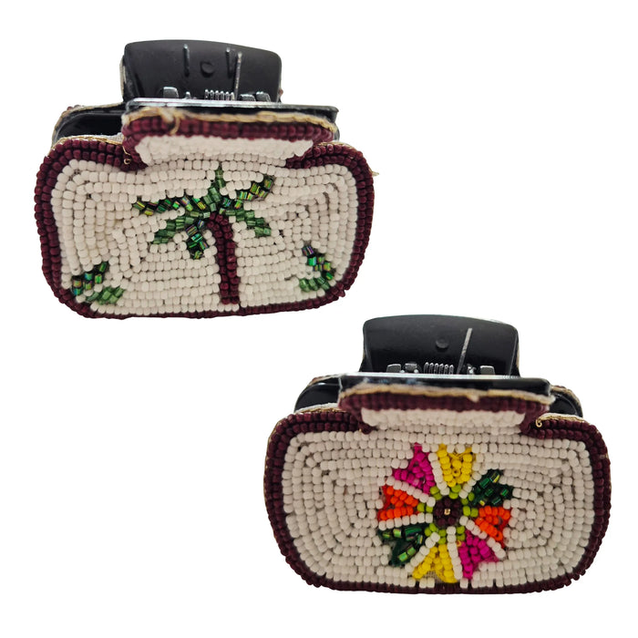 Two views of a cream beaded hair claw clip with burgundy edging, a green palm tree on one side and a multicoloured flower on the other
