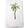 White cotton hand towel with embroidered palm tree motif folded on white background
