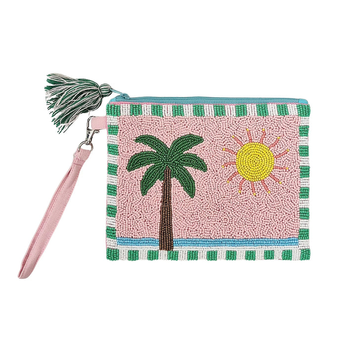 Pink beaded clutch with a green palm tree, yellow sun, green and white striped edging, pink wrist strap and green and white tasselled zip pull
