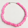 Pink candy puka shell necklace on white background - Travel and Tide