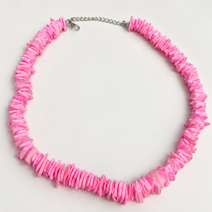 Pink candy puka shell necklace on white background - Travel and Tide