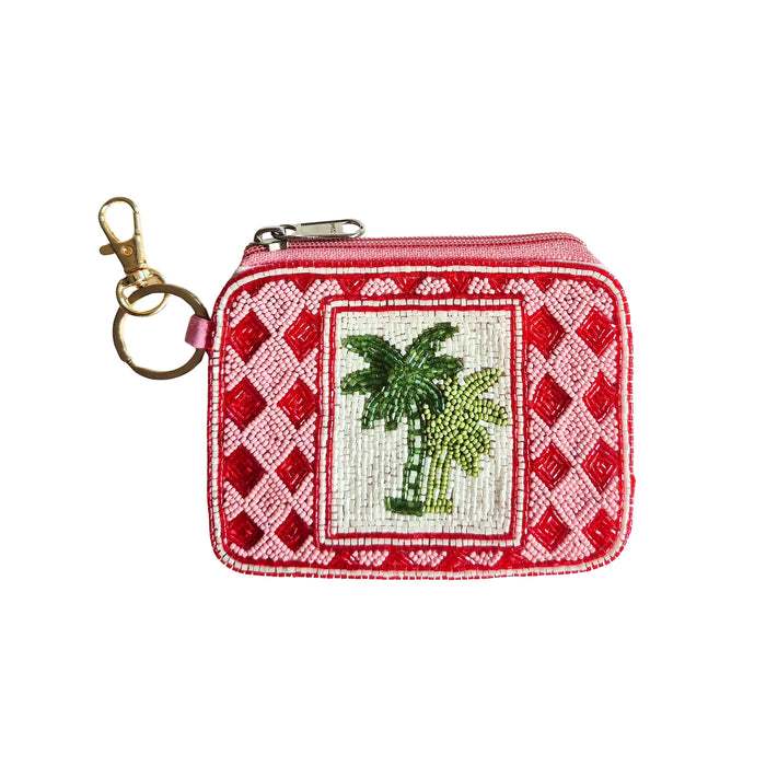 Beaded keychain pouch with two green palm trees on a cream panel, red and pink diamond-patterned borders, pink zip and gold-tone keyring clip
